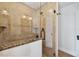 Tiled shower stall with frameless glass door, granite accent, and shower head at 4016 N Seminole Ave, Tampa, FL 33603
