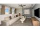 Cozy living room area with modern furnishings, large windows, and a stylish entertainment center at 4221 Goldfoil Rd, Spring Hill, FL 34609