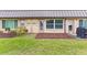 The back of the house shows doors leading to the grassy backyard at 4305 Summersun Dr, New Port Richey, FL 34652