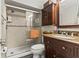 Bathroom boasts a glass door shower, wood cabinet, granite counter, and tiled walls at 4305 Summersun Dr, New Port Richey, FL 34652