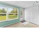Light-filled bedroom features large window, neutral carpet, and door to the backyard at 4305 Summersun Dr, New Port Richey, FL 34652