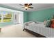 Cozy bedroom featuring bright, green walls, a ceiling fan, and an exit to the backyard at 4305 Summersun Dr, New Port Richey, FL 34652