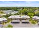 Low angle shot of a multi-unit residential building with attached covered parking and well-maintained landscaping at 4305 Summersun Dr, New Port Richey, FL 34652