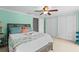 Bright main bedroom with green walls, neutral carpet, ceiling fan, and multiple closets at 4305 Summersun Dr, New Port Richey, FL 34652