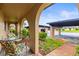 Welcoming front porch with a seating area and colorful cushions, with the parking area in the background at 4305 Summersun Dr, New Port Richey, FL 34652