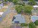 An aerial view of a single-story home in a residential neighborhood, featuring solar panels at 4623 Wisteria Dr, Zephyrhills, FL 33542