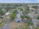 An aerial view of a residential neighborhood, featuring a single-story home with solar panels at 4623 Wisteria Dr, Zephyrhills, FL 33542