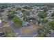 A picturesque aerial view of a quiet neighborhood featuring a single-story home with solar panels at 4623 Wisteria Dr, Zephyrhills, FL 33542