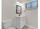 This bathroom features a white vanity, framed mirror, and modern fixtures at 4623 Wisteria Dr, Zephyrhills, FL 33542