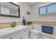This bathroom features a white vanity, and a horizontal tiled accent on the wall at 4623 Wisteria Dr, Zephyrhills, FL 33542