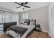The bedroom is naturally lit and has wood flooring, a ceiling fan and neutral paint at 4623 Wisteria Dr, Zephyrhills, FL 33542