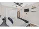 The bedroom has neutral paint, a ceiling fan, wood flooring, and a large closet at 4623 Wisteria Dr, Zephyrhills, FL 33542