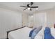Bedroom featuring a bright window and a closet with folding doors, and the bed is nicely decorated at 4623 Wisteria Dr, Zephyrhills, FL 33542