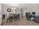 Dining room with dark wood table, stylish chandelier, and wood-look flooring at 4623 Wisteria Dr, Zephyrhills, FL 33542