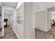 The hallway includes wood flooring, neutral paint, and access to bedrooms and closets at 4623 Wisteria Dr, Zephyrhills, FL 33542
