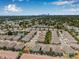 An aerial view showcases the neighborhood with water feature and manicured lawns with the city skyline in the background at 5176 6Th N St, St Petersburg, FL 33703