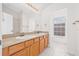 Bathroom with large mirror, double sinks and tile floor at 5176 6Th N St, St Petersburg, FL 33703