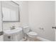 Small powder room with a pedestal sink at 5176 6Th N St, St Petersburg, FL 33703