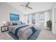Bedroom with three windows and white drapes, ceiling fan, bed with two nightstands at 5176 6Th N St, St Petersburg, FL 33703