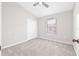 Bedroom with a ceiling fan, carpet, window with blinds and closet at 5176 6Th N St, St Petersburg, FL 33703