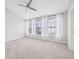 Bedroom with three windows with white drapes, carpet and ceiling fan at 5176 6Th N St, St Petersburg, FL 33703