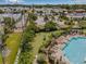 Overhead view of a pool, lawn and dog area, surrounded by lush landscaping and seating areas in the community at 5176 6Th N St, St Petersburg, FL 33703