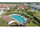 A bird's-eye view of a community pool and seating area, beautifully landscaped and surrounded by greenery at 5176 6Th N St, St Petersburg, FL 33703