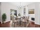 Stylishly furnished dining room featuring hardwood floors, a modern chandelier, and a glass table set for a meal at 5176 6Th N St, St Petersburg, FL 33703