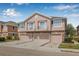 View of a two-story townhome with a multi-car garage and quaint balconies under a blue sky at 5176 6Th N St, St Petersburg, FL 33703