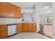 Kitchen sink with wood cabinets and view to the living area at 5176 6Th N St, St Petersburg, FL 33703