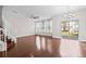 Bright living room featuring hardwood floors, natural light from windows, and a staircase leading to the upper level at 5176 6Th N St, St Petersburg, FL 33703