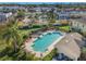 Aerial view of a community pool with lounge chairs and manicured landscaping, offering a relaxing outdoor space at 5176 6Th N St, St Petersburg, FL 33703