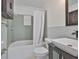 Bathroom with a tub and shower combination, shower curtain, and single sink vanity at 5219 4Th S St, St Petersburg, FL 33705