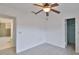 Bedroom with light walls and floors, ceiling fan, and two closets at 5219 4Th S St, St Petersburg, FL 33705