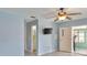 A brightly lit bedroom with a ceiling fan and access to the ensuite bathroom and lanai at 5219 4Th S St, St Petersburg, FL 33705