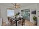 Bright dining room with a ceiling fan, area rug, and sliding glass doors to a sunroom at 5219 4Th S St, St Petersburg, FL 33705