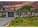 Charming single-story home featuring a well-maintained lawn and mature trees at sunset at 5219 4Th S St, St Petersburg, FL 33705