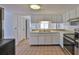 A well-lit kitchen with tile flooring and stainless steel appliances at 5219 4Th S St, St Petersburg, FL 33705
