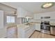 Well-lit kitchen featuring tile flooring, white cabinets, and stainless steel appliances at 5219 4Th S St, St Petersburg, FL 33705