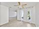 Spacious living area with fan, lots of light, and view to another room at 5219 4Th S St, St Petersburg, FL 33705
