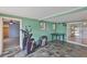 Recreation room features colorful tiled floor, windows, and exercise equipment at 5219 4Th S St, St Petersburg, FL 33705