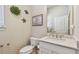 Stylish half bathroom featuring modern fixtures, elegant decor, and a pristine white vanity with stone countertop at 6140 Marina Cove S Way, St Petersburg, FL 33712