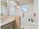 Contemporary shower with a glass door, marble tile, and a built-in shower bench at 6140 Marina Cove S Way, St Petersburg, FL 33712