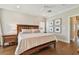 Inviting bedroom with a rustic wooden bed frame, hardwood floors, and simple wall art at 6140 Marina Cove S Way, St Petersburg, FL 33712