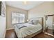 Cozy bedroom with a queen-sized bed, hardwood floors, and a window providing natural light at 6140 Marina Cove S Way, St Petersburg, FL 33712