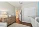 Bedroom featuring hardwood floors, a wooden dresser, and two closets along with white crib at 6140 Marina Cove S Way, St Petersburg, FL 33712