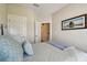 Cozy bedroom featuring neutral walls, a comfortable bed, and tranquil beach-themed artwork at 6140 Marina Cove S Way, St Petersburg, FL 33712