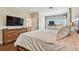 Spacious bedroom with a large dresser, TV, and an ensuite bathroom for added convenience at 6140 Marina Cove S Way, St Petersburg, FL 33712