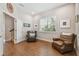 Bonus room with hardwood floors, natural light, and comfortable armchairs at 6140 Marina Cove S Way, St Petersburg, FL 33712