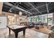 View of the common area with a pool table, comfortable seating, and an open layout with large windows at 6140 Marina Cove S Way, St Petersburg, FL 33712